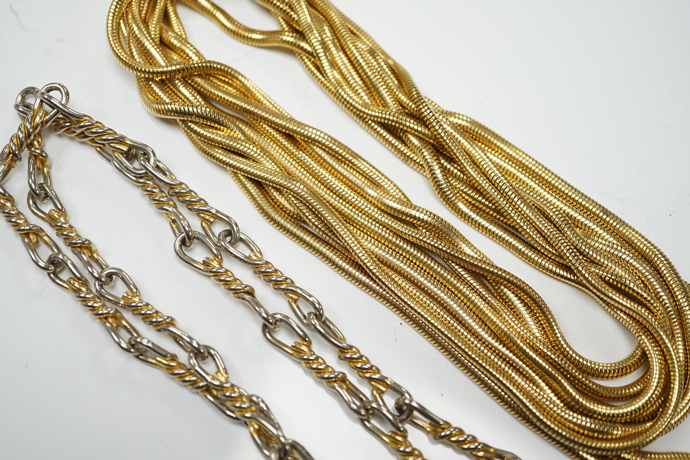 A Christian Dior multi strand gilt metal snake link necklace, 90cm, together with a Christian Dior two colour metal spiral chain link necklace, 78cm, both signed.
